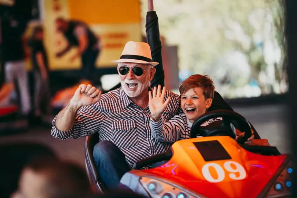 Grandson and Grandfather riding in a bumper car
